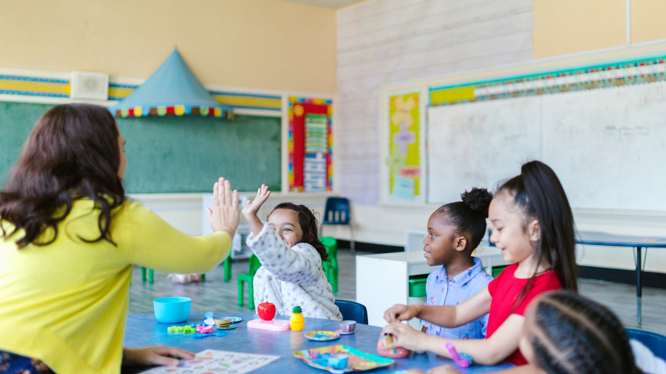 SANTS Blog Header Image Teacher praising child with high five